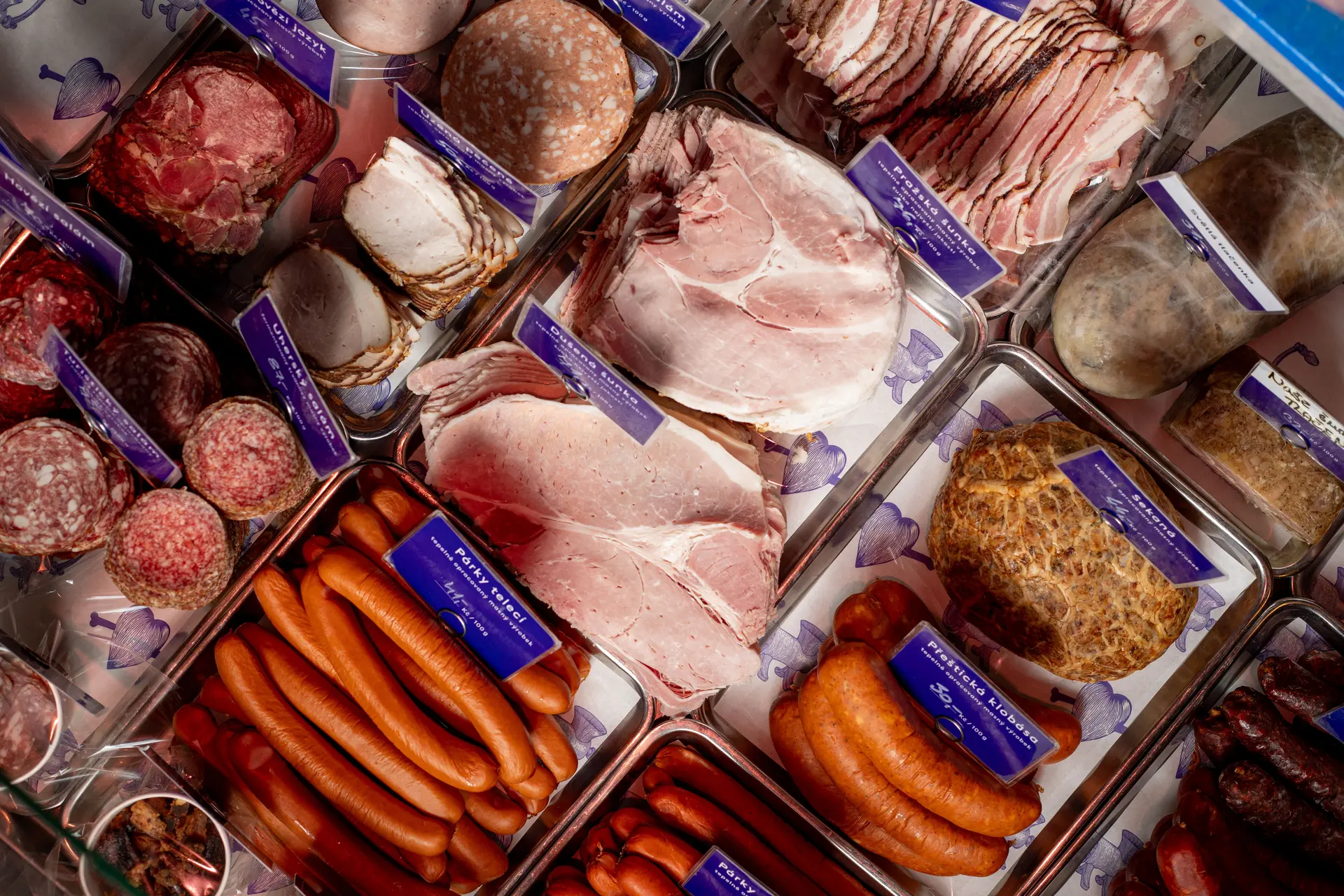 Deli counter with sausages and sliced meats.